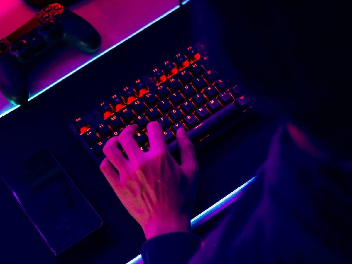Ręce gracza na klawiaturze. Obrazek w artykule Idealny sprzęt komputerowy dla graczy komputerowych. Jak wybrać najlepszy sprzęt dla swoich potrzeb?